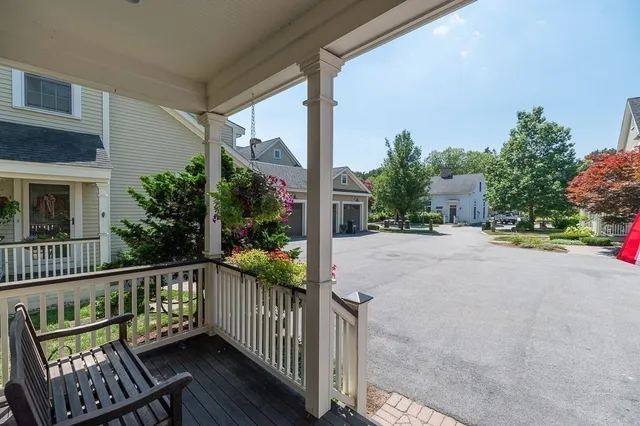 a view of a street with wooden fence