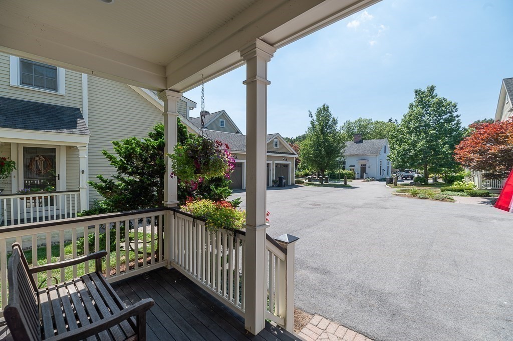 12 Wallis Drive, Unit 12 Wenham, MA 01984 - Photo 4 of 35 a view of a street with wooden fence