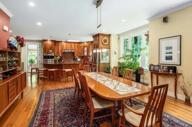 a dining room with furniture and wooden floor