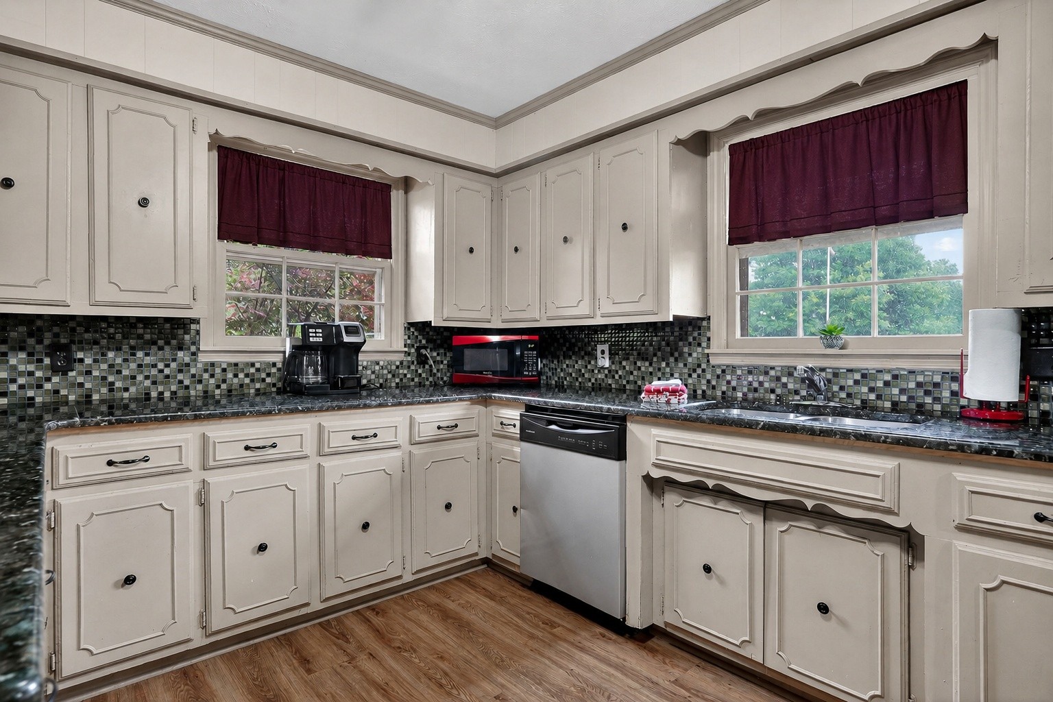 5642 Pates Ford Road Smithville, TN 37166 - Photo 8 of 32 a kitchen with stainless steel appliances granite countertop a stove a sink and white cabinets
