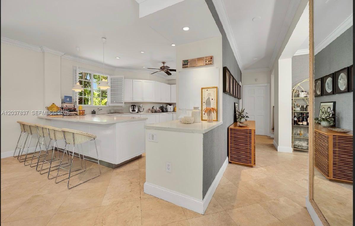797 Glenridge Road Key Biscayne, FL 33149 - Photo 12 of 39 a kitchen with kitchen island granite countertop a sink cabinets and window
