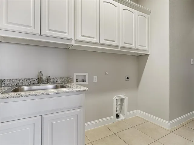 a kitchen with white cabinets and a sink