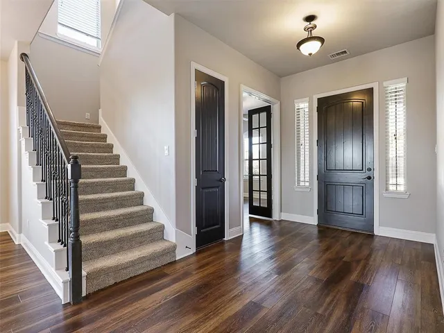 a view of an entryway with wooden floor