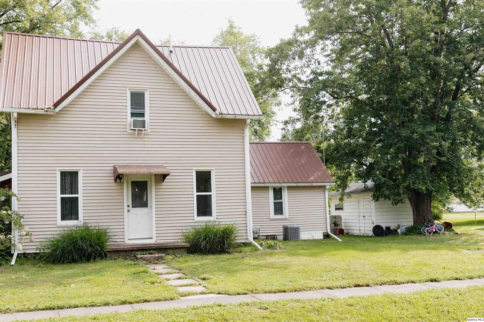 410 South Park Street Golden, IL 62339 - Photo 2 of 12 a view of a yard in front of a house with garage
