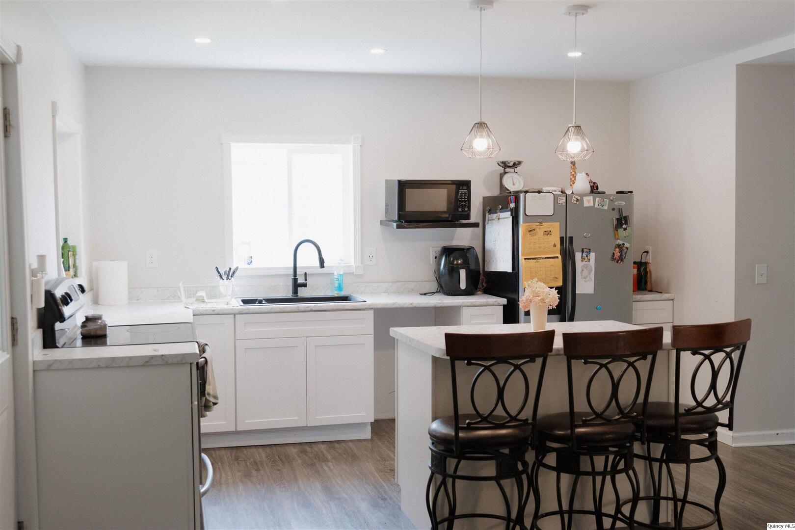 410 South Park Street Golden, IL 62339 - Photo 3 of 12 a kitchen with a sink cabinets and window
