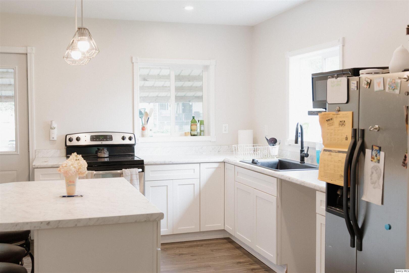 410 South Park Street Golden, IL 62339 - Photo 6 of 12 a kitchen with a sink a stove and refrigerator