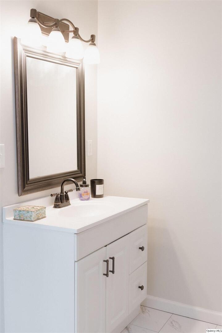 410 South Park Street Golden, IL 62339 - Photo 9 of 12 a bathroom with a sink and a mirror