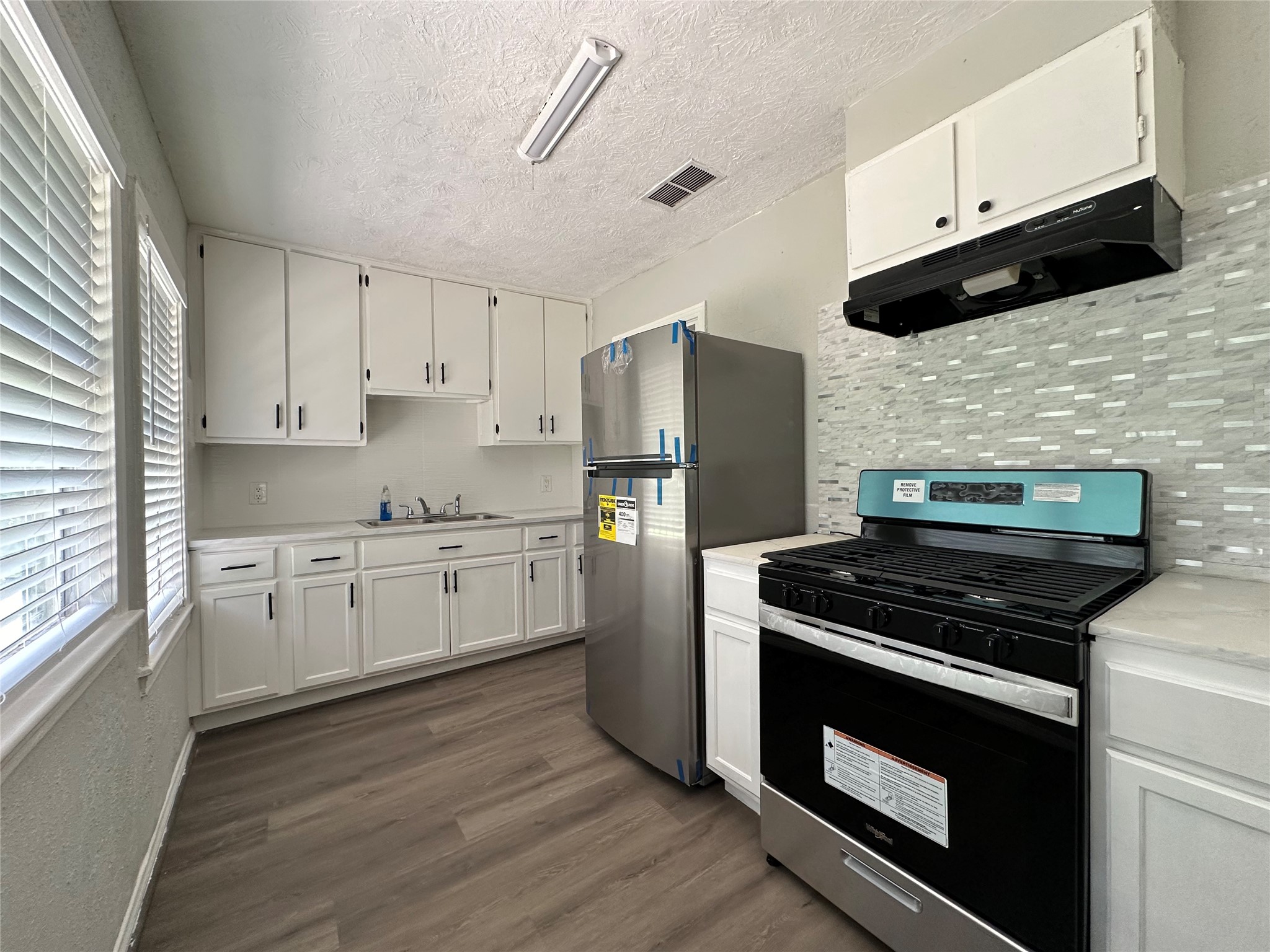 3723 Cosby Street Houston, TX 77021 - Photo 6 of 14 a kitchen with granite countertop cabinets and steel stainless steel appliances