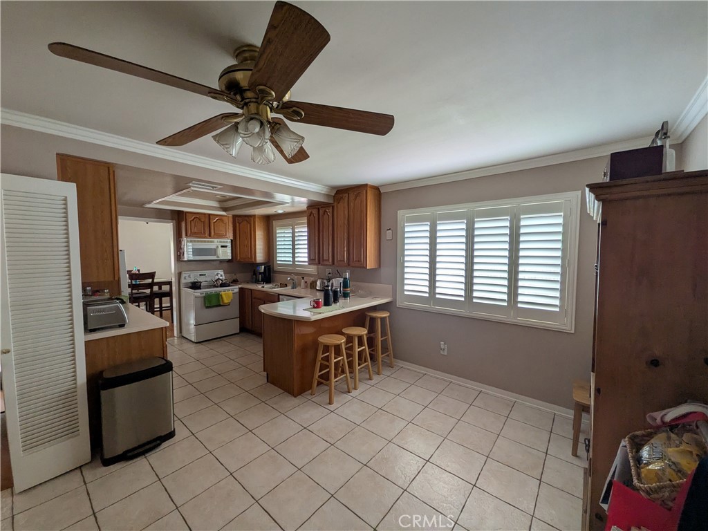 15739 Lone Ridge Place La Mirada, CA 90638 - Photo 13 of 39 a kitchen with granite countertop a sink a counter top space appliances and cabinets