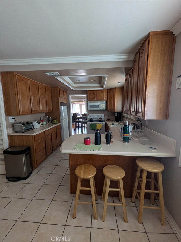 15739 Lone Ridge Place La Mirada, CA 90638 - Photo 14 of 39 a kitchen with stainless steel appliances granite countertop a stove a sink a microwave and a refrigerator