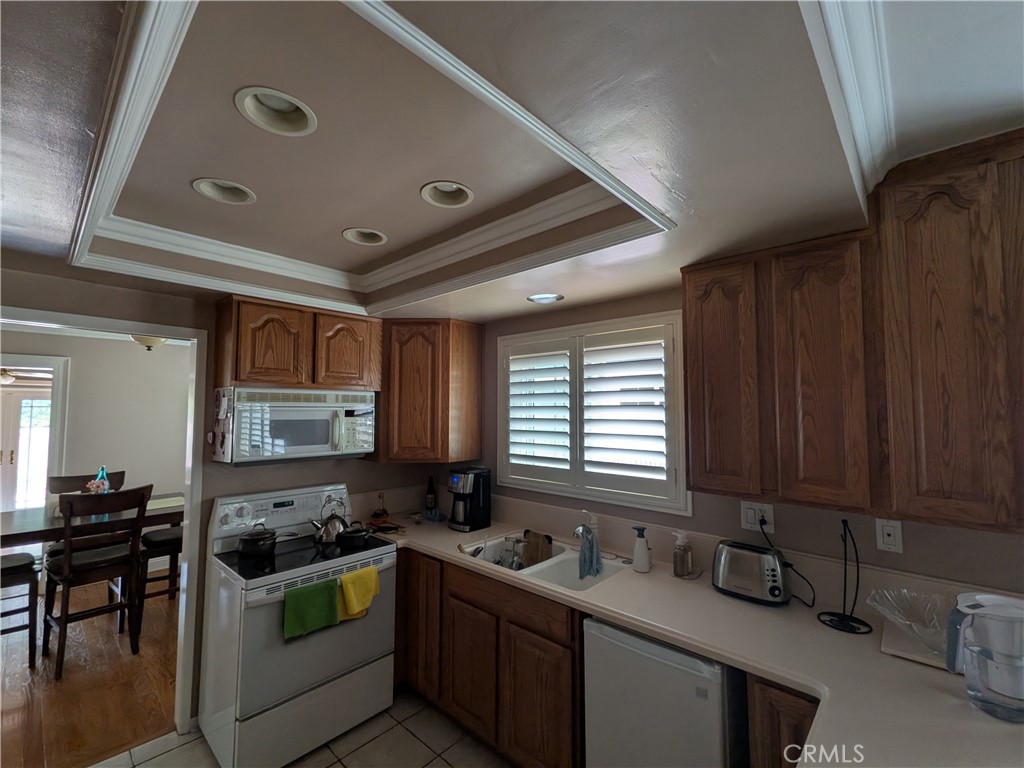 15739 Lone Ridge Place La Mirada, CA 90638 - Photo 15 of 39 a kitchen with stainless steel appliances granite countertop sink stove and cabinets