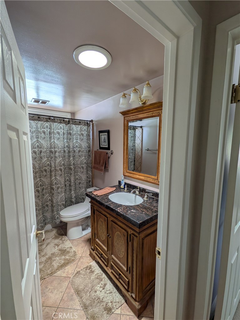 15739 Lone Ridge Place La Mirada, CA 90638 - Photo 20 of 39 a bathroom with a granite countertop sink and a mirror