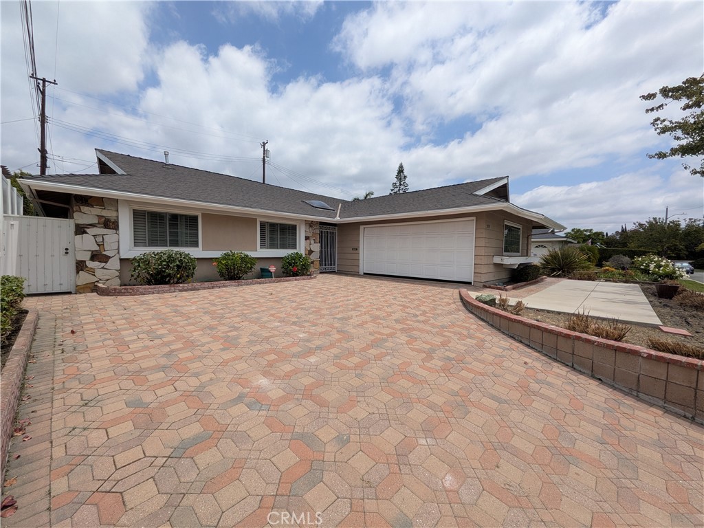 15739 Lone Ridge Place La Mirada, CA 90638 - Photo 2 of 39 a front view of a house with a yard and potted plants