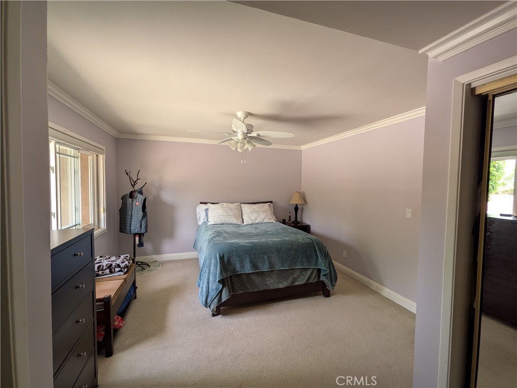 15739 Lone Ridge Place La Mirada, CA 90638 - Photo 23 of 39 a bedroom with a bed and a chandelier