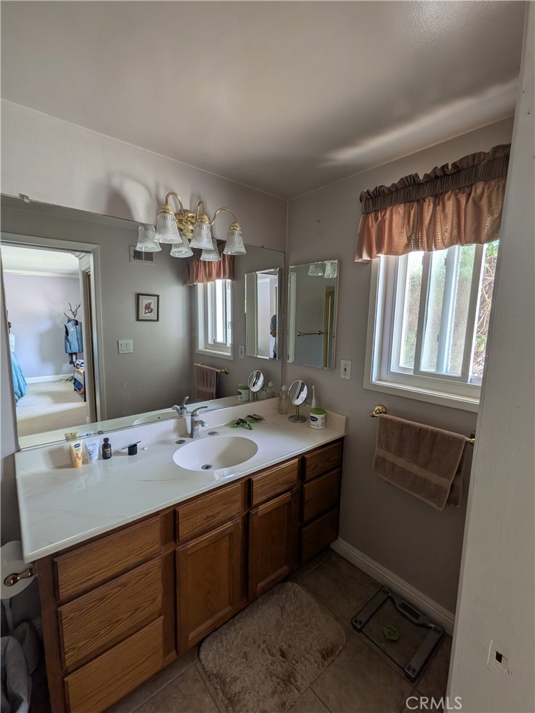 15739 Lone Ridge Place La Mirada, CA 90638 - Photo 24 of 39 a spacious bathroom with a double vanity sink and a mirror