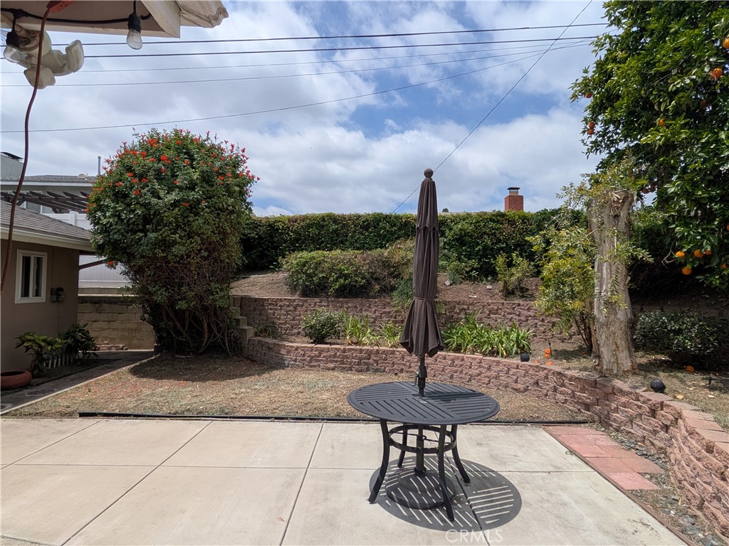 15739 Lone Ridge Place La Mirada, CA 90638 - Photo 29 of 39 a view of a patio with table and chairs potted plants and a fountain