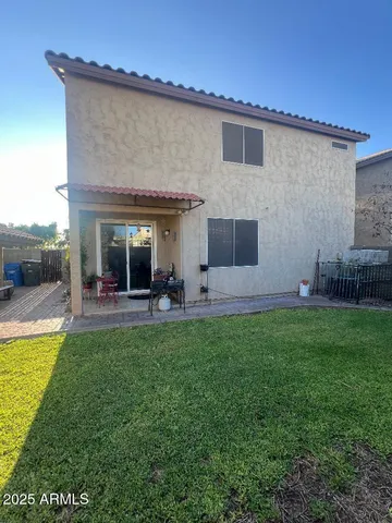 a view of a house with backyard and sitting area