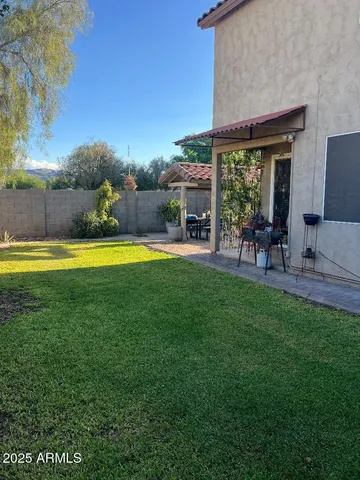 a view of a swimming pool with lawn chairs and a table and chairs