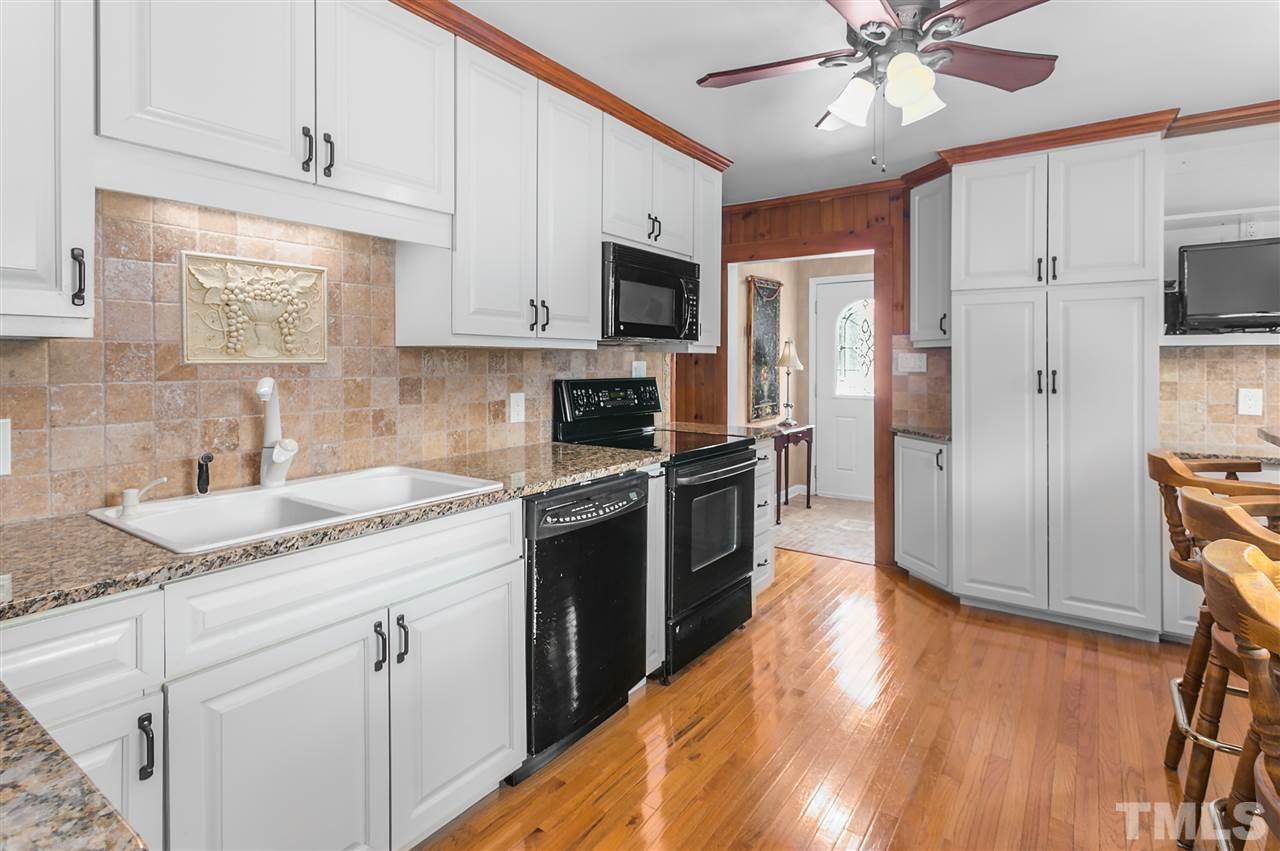 5270 Six Forks Road Raleigh, NC 27609 - Photo 12 of 30 a kitchen with stainless steel appliances granite countertop a refrigerator a sink dishwasher a stove and white cabinets with wooden floor