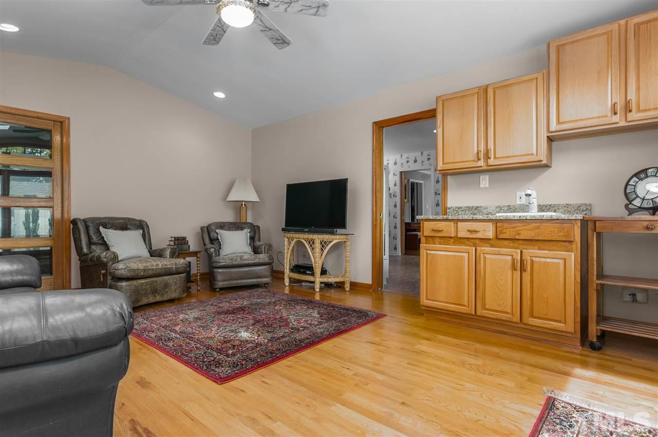 5270 Six Forks Road Raleigh, NC 27609 - Photo 14 of 30 a living room with furniture a flat screen tv and kitchen view