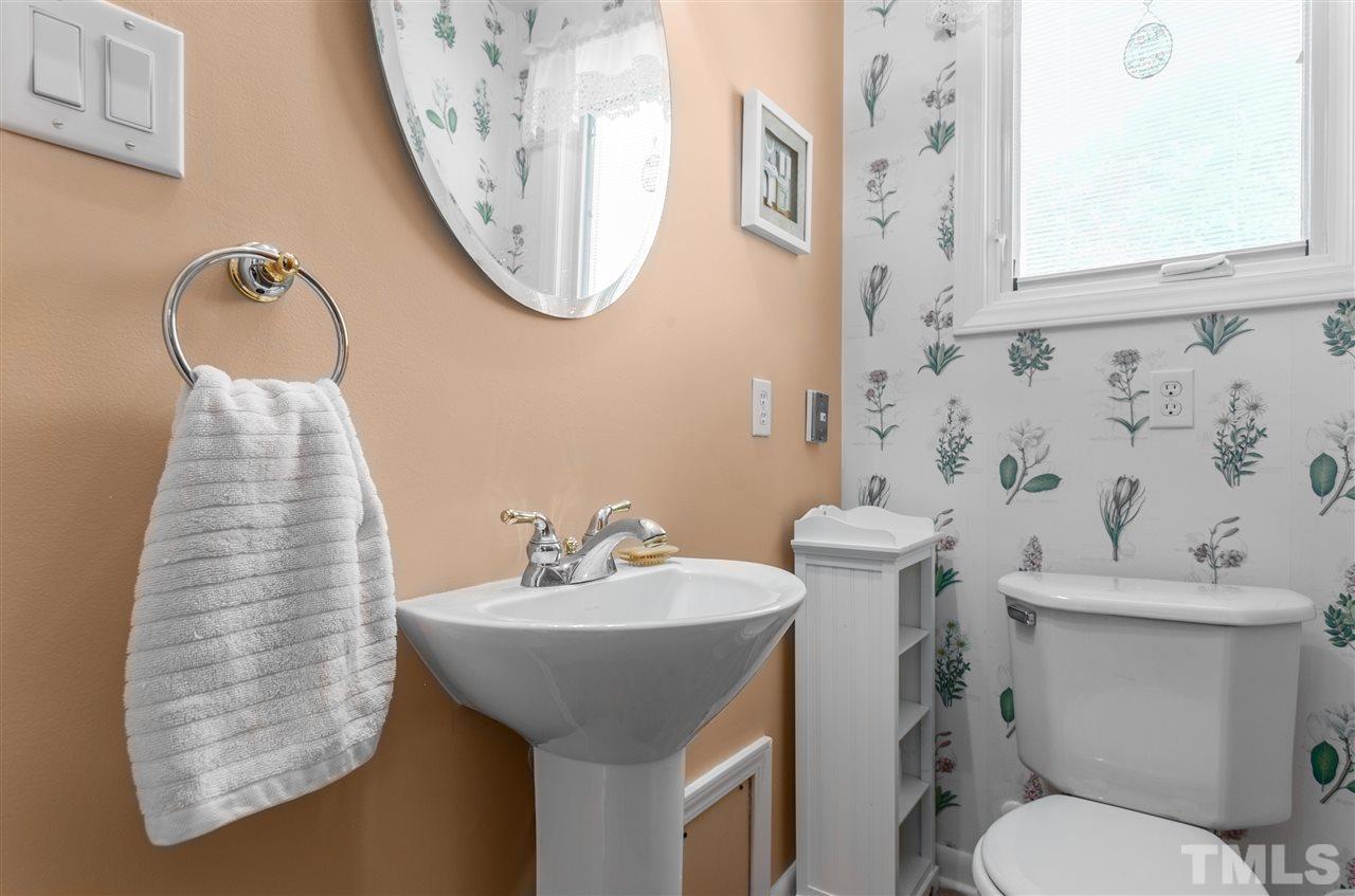 5270 Six Forks Road Raleigh, NC 27609 - Photo 16 of 30 a bathroom with a sink a toilet and a mirror