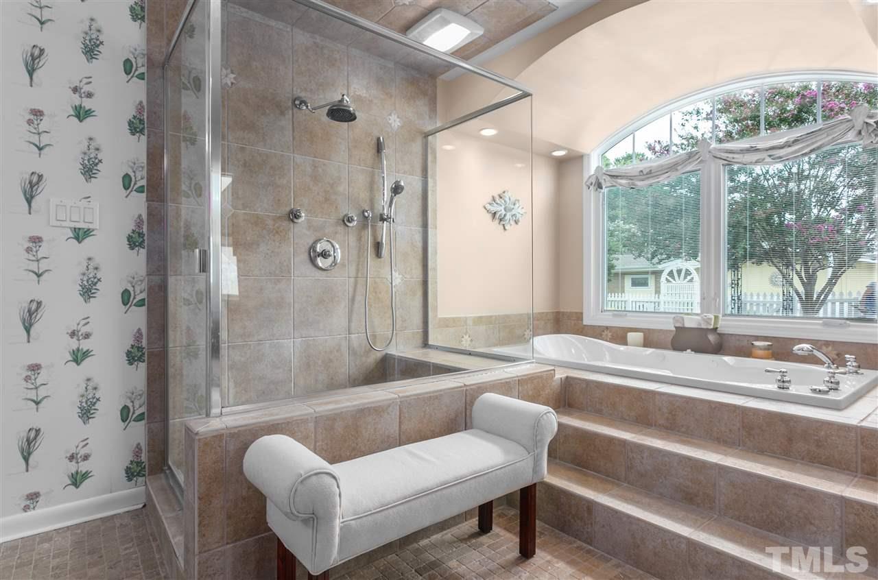 5270 Six Forks Road Raleigh, NC 27609 - Photo 18 of 30 a bathroom with a tub and a large window