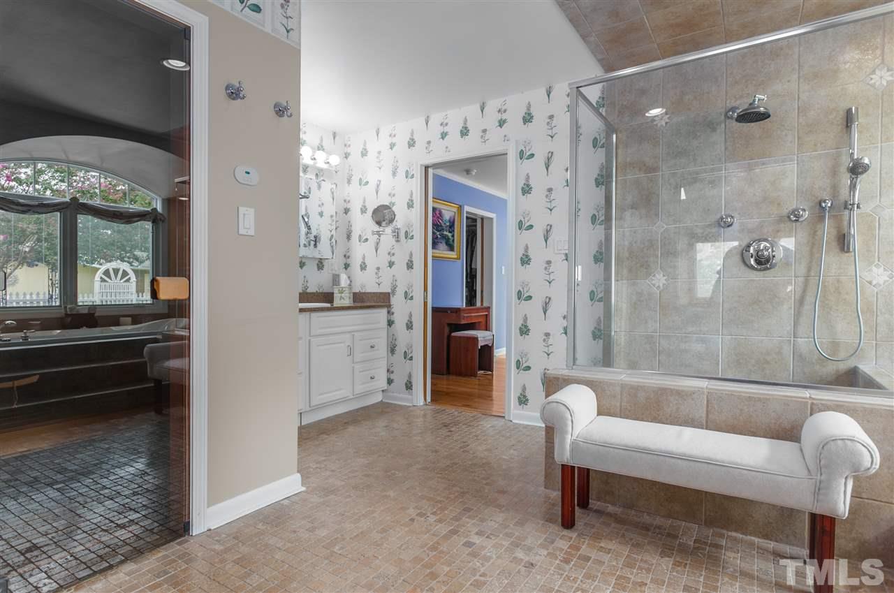 5270 Six Forks Road Raleigh, NC 27609 - Photo 19 of 30 a bathroom with a tub shower and sink