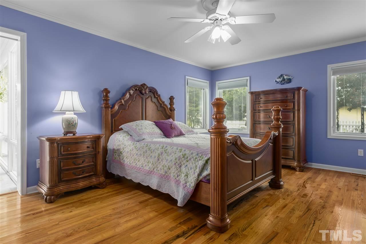 5270 Six Forks Road Raleigh, NC 27609 - Photo 20 of 30 a bed room with a bed and a chandelier