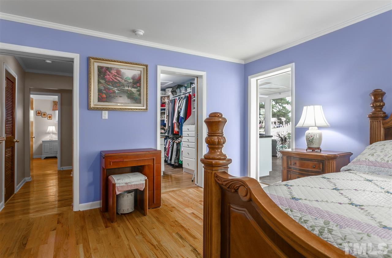 5270 Six Forks Road Raleigh, NC 27609 - Photo 21 of 30 a bedroom with furniture and a wooden floor
