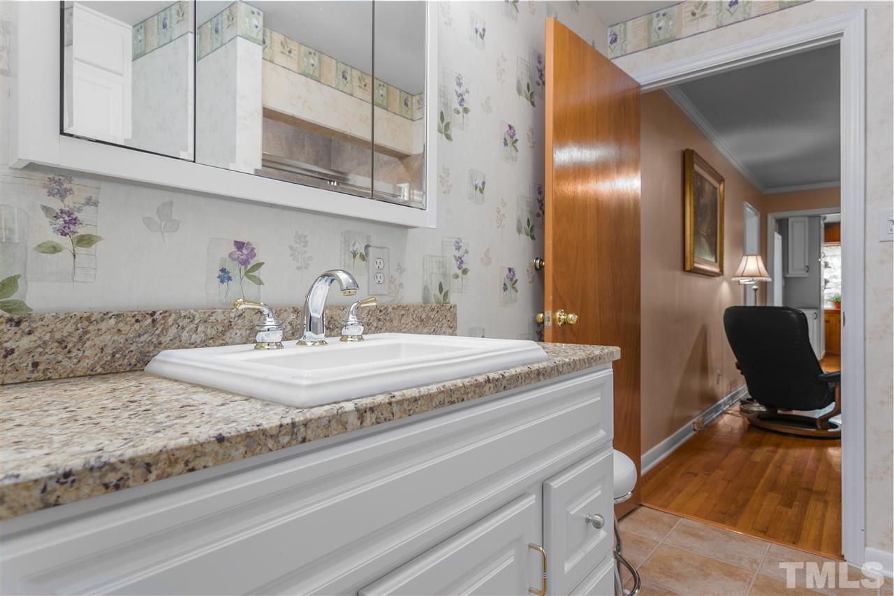 5270 Six Forks Road Raleigh, NC 27609 - Photo 24 of 30 a bathroom with a granite countertop sink and a mirror