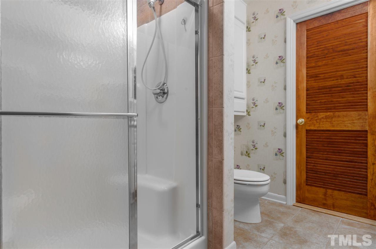 5270 Six Forks Road Raleigh, NC 27609 - Photo 25 of 30 a bathroom with a granite countertop sink toilet and shower