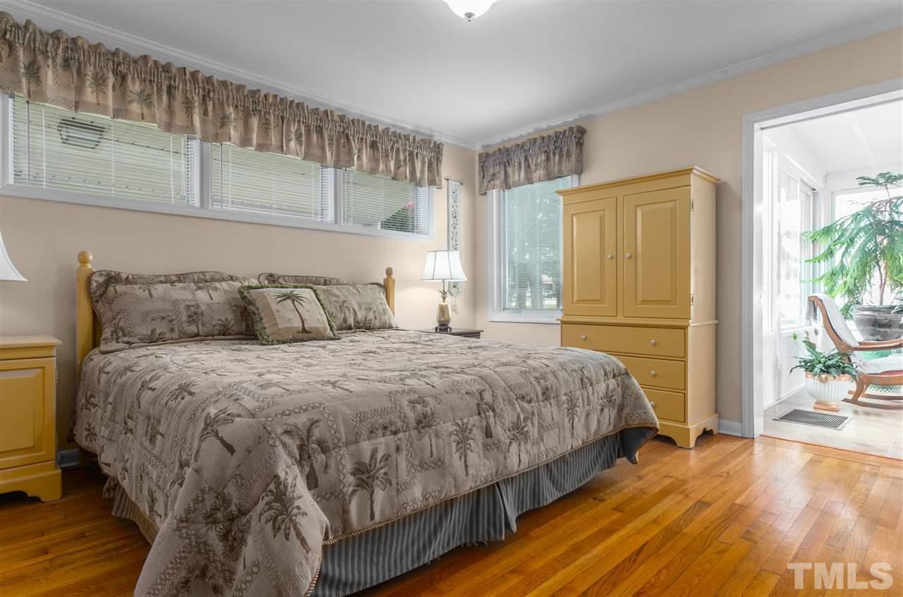 5270 Six Forks Road Raleigh, NC 27609 - Photo 28 of 30 a bedroom with a bed and a flat tv screen on the dresser