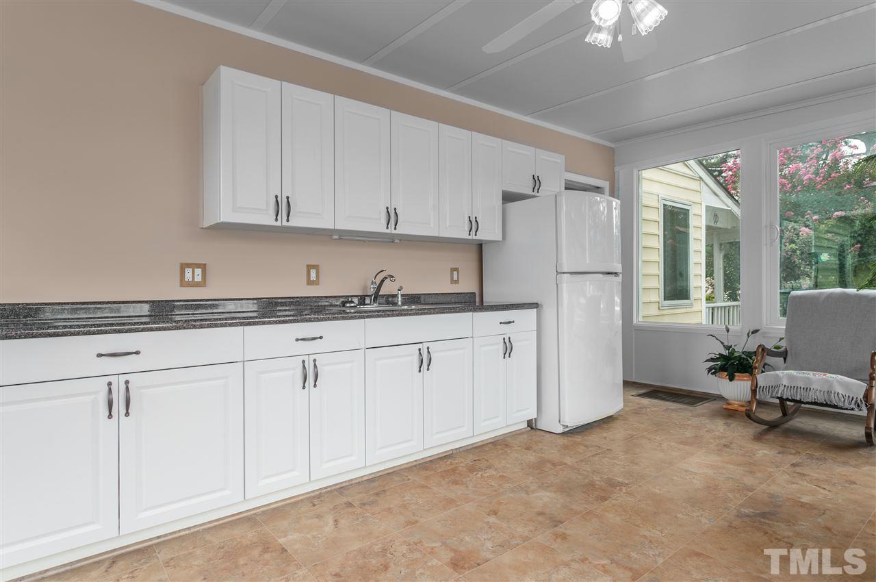 5270 Six Forks Road Raleigh, NC 27609 - Photo 29 of 30 a kitchen with granite countertop white cabinets and white appliances