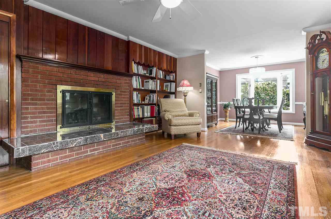 5270 Six Forks Road Raleigh, NC 27609 - Photo 8 of 30 a living room with furniture wooden floor and a fireplace