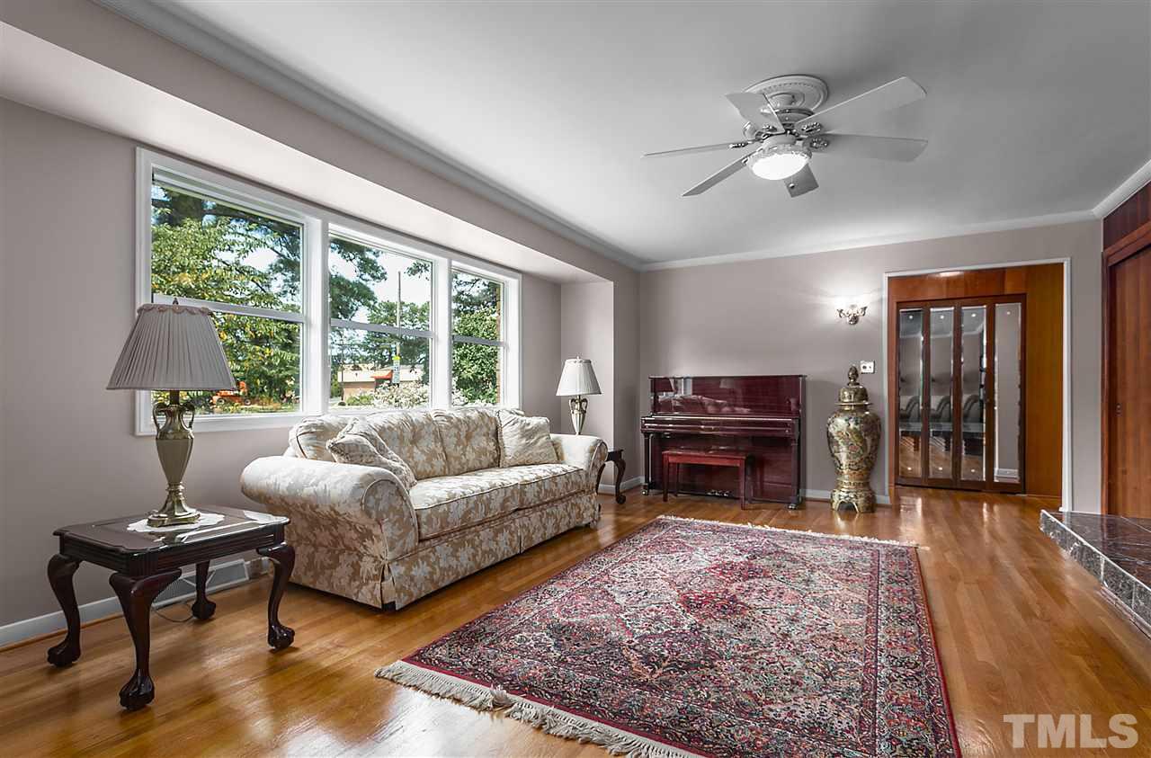 5270 Six Forks Road Raleigh, NC 27609 - Photo 10 of 30 a living room with furniture a rug and a large window