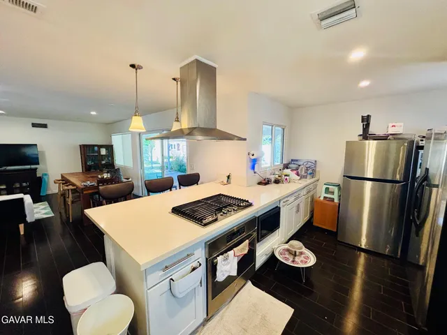 a kitchen with a appliances and a refrigerator