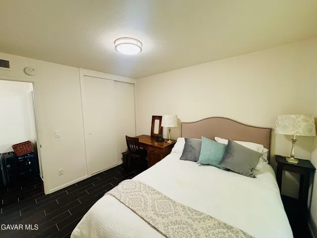 a bedroom with a bed and a night stand