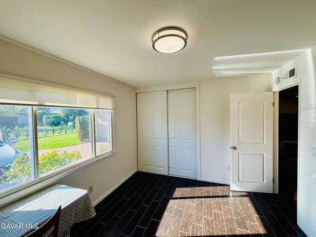 a view of a room with wooden floor and windows