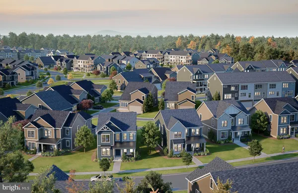an aerial view of residential houses with yard and lake view
