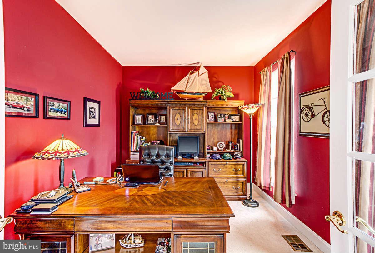 605 Sand Road Severn, MD 21144 - Photo 11 of 30 a living room with furniture a fireplace and a flat screen tv