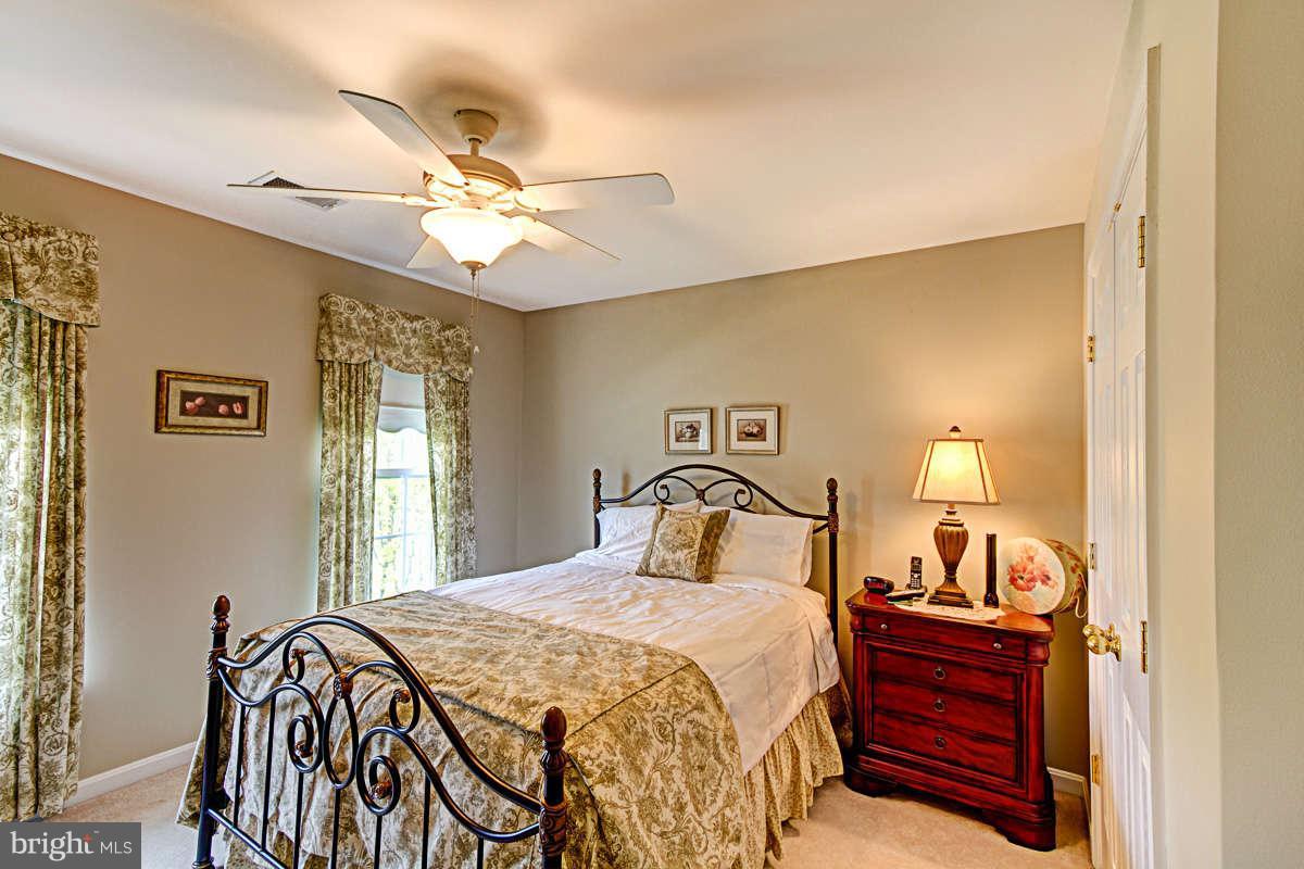 605 Sand Road Severn, MD 21144 - Photo 17 of 30 a bedroom with a bed and a chandelier