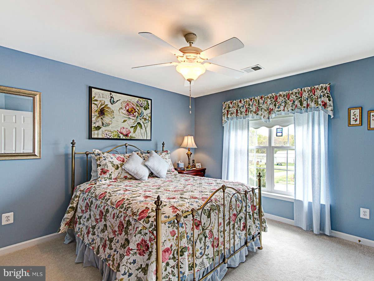 605 Sand Road Severn, MD 21144 - Photo 18 of 30 a bedroom with a bed and a chandelier