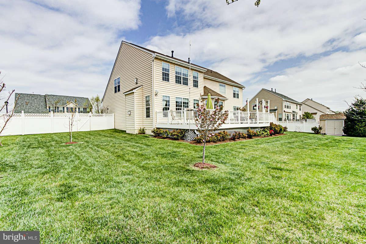 605 Sand Road Severn, MD 21144 - Photo 24 of 30 a front view of a house with a yard and trees