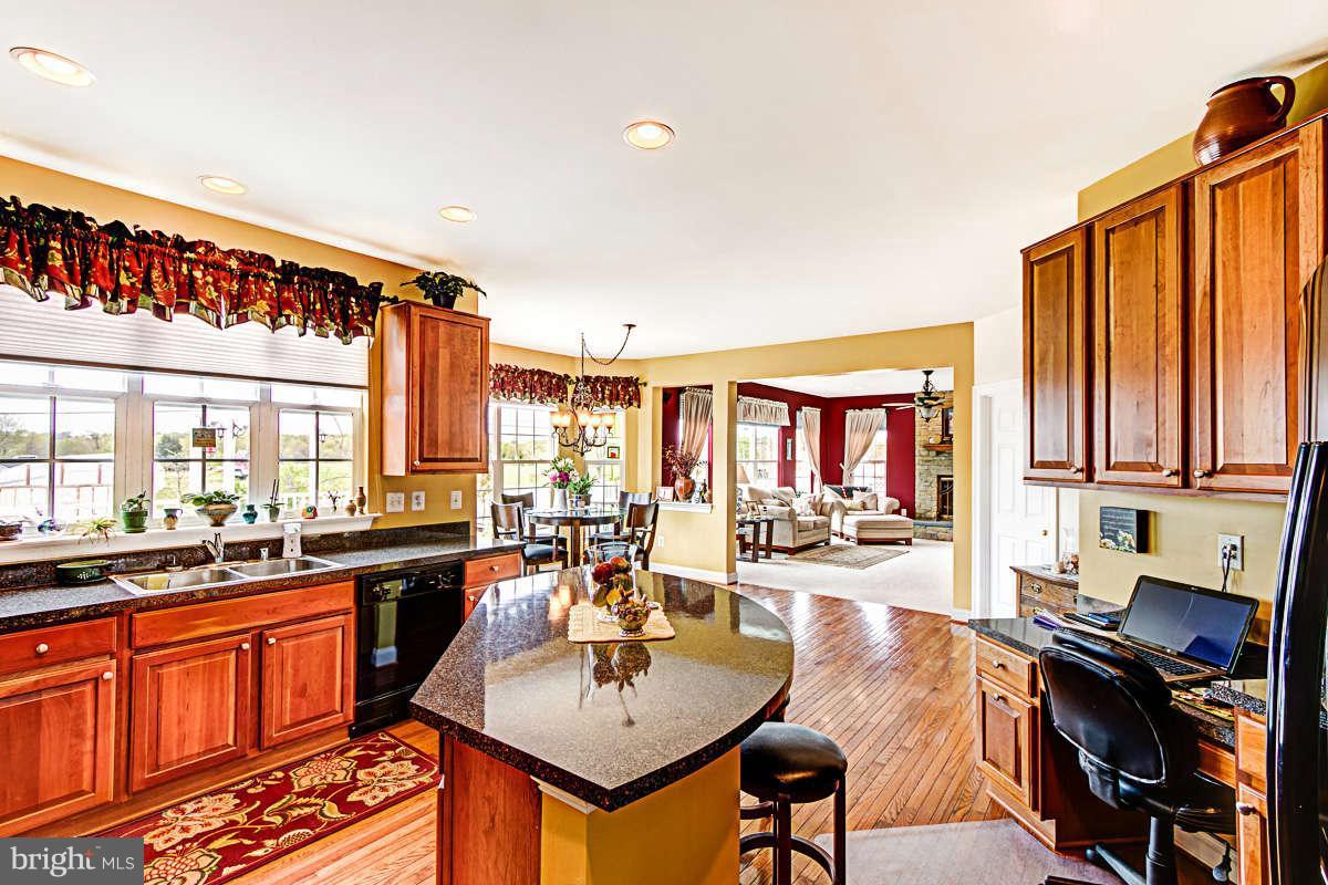 605 Sand Road Severn, MD 21144 - Photo 5 of 30 a open kitchen with stainless steel appliances granite countertop a sink and cabinets