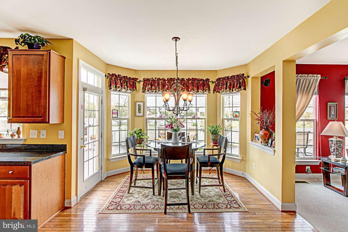 605 Sand Road Severn, MD 21144 - Photo 8 of 30 a view of a dining room with furniture window and wooden floor