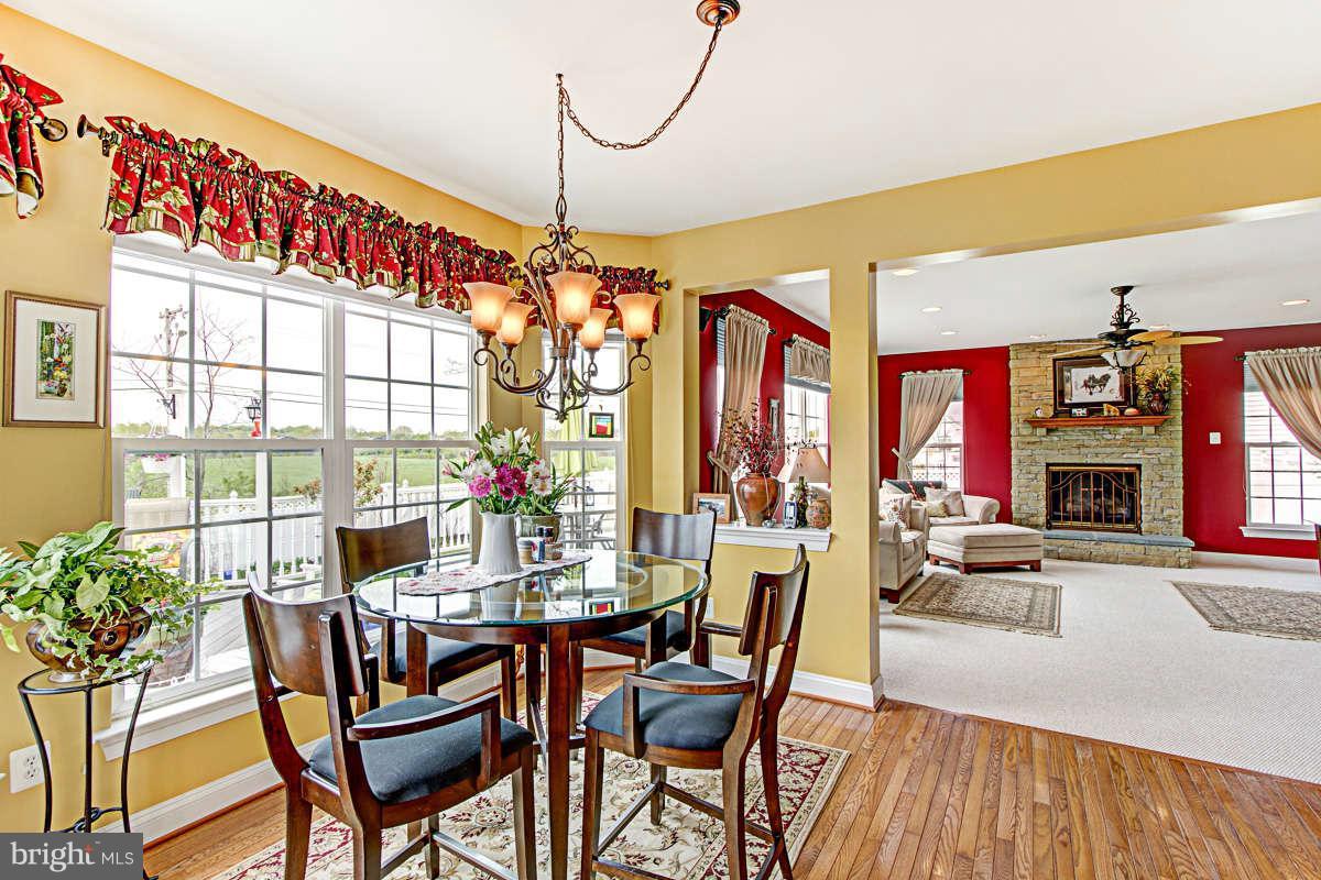 605 Sand Road Severn, MD 21144 - Photo 9 of 30 a view of a dining room with furniture window and wooden floor