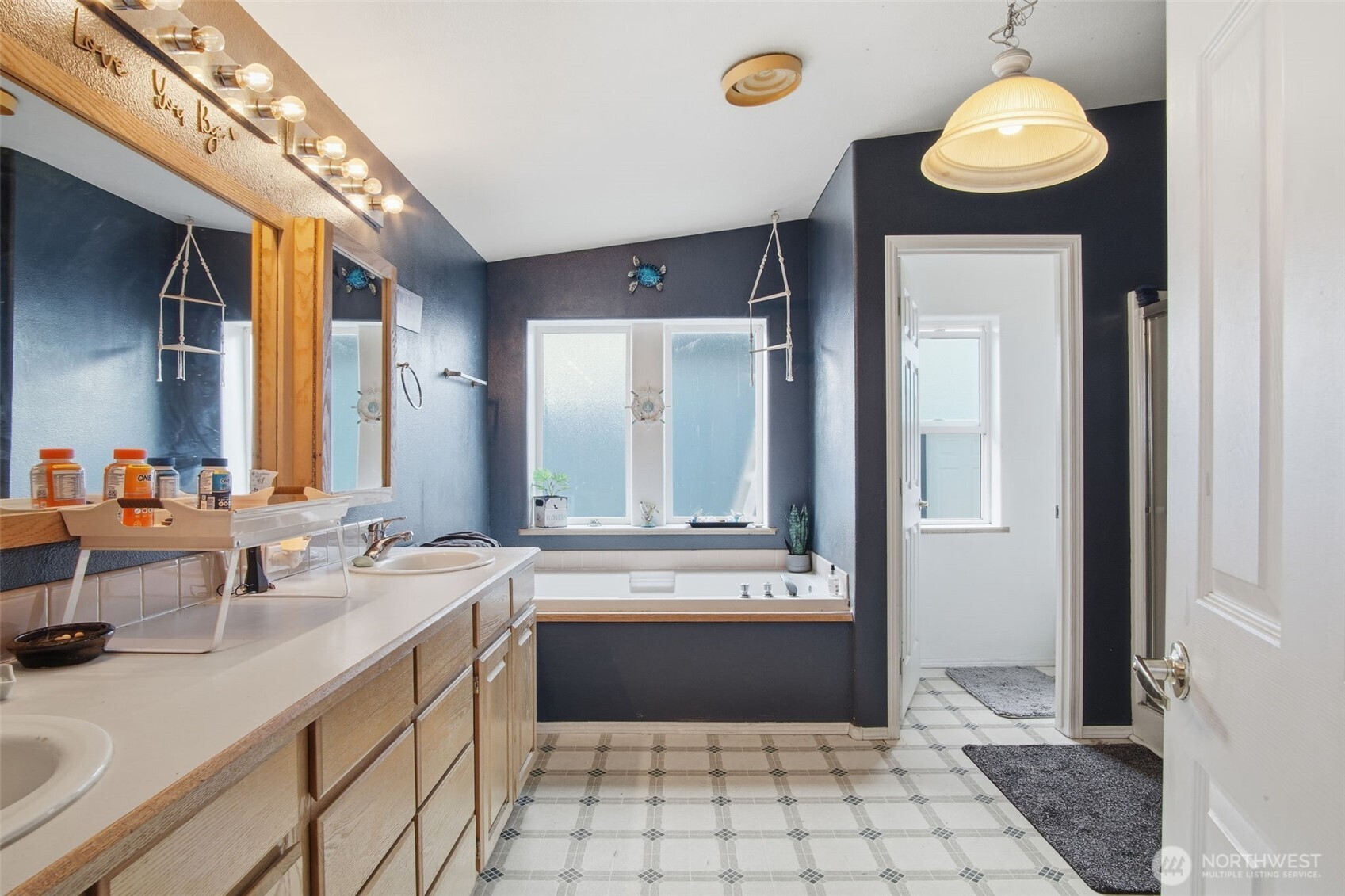 261 Hardy Road Lamont, WA 99017 - Photo 14 of 40 a bathroom with a sink a large mirror and a bathtub with shower