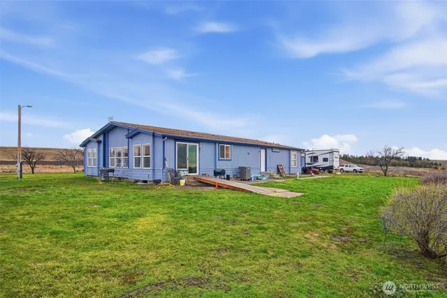 a house view with a sitting space and garden