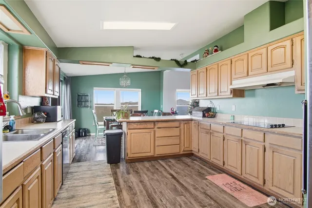a kitchen with cabinets oven and a sink