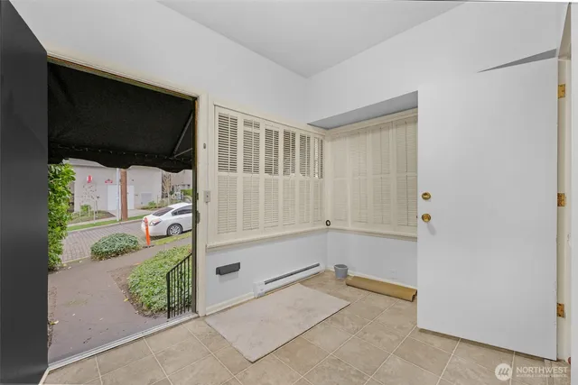 a view of a hardwood floor and an empty room